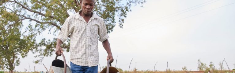 Farmer waters his plants