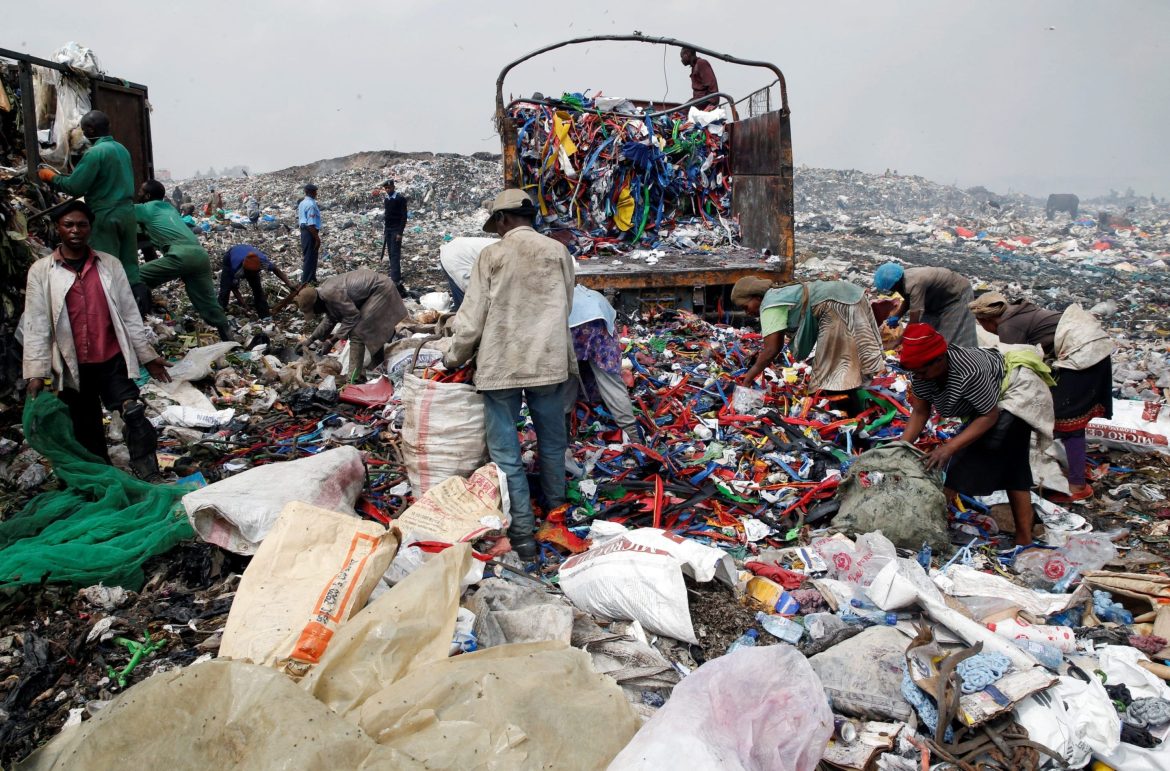 Scavengers sort recyclable plastic materials at the Dandora dumping site on the outskirts of Nairobi People at a dump site outside Nairobi